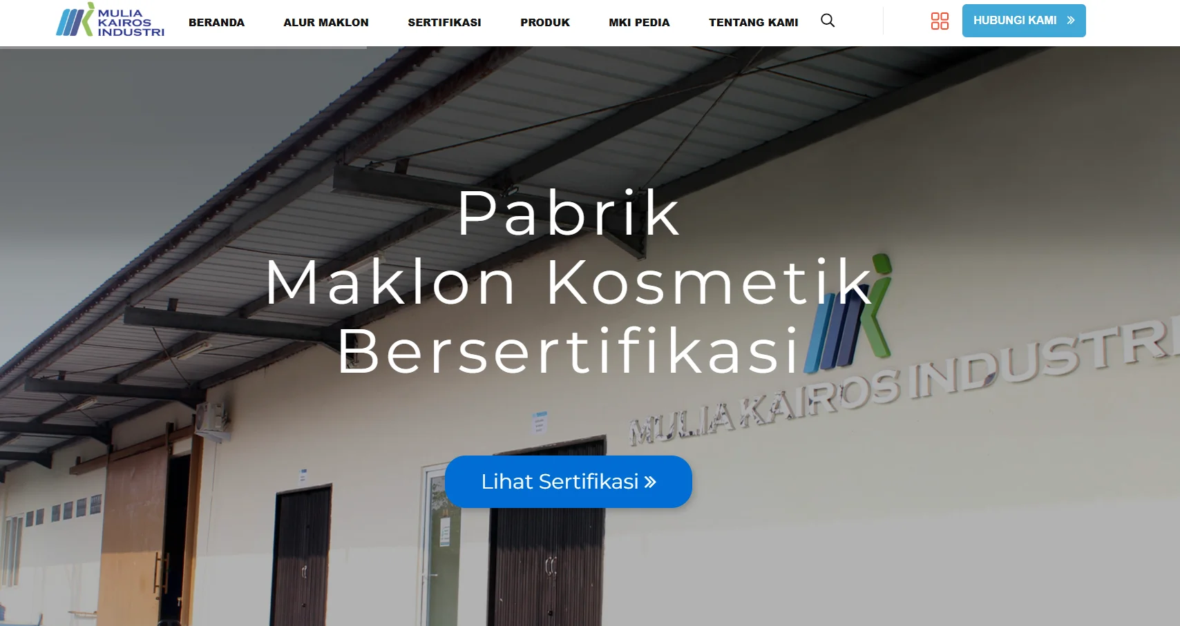 Exterior view of a certified cosmetic manufacturing facility with signage reading Mulia Kairos Industri and a call-to-action button for certification details.
