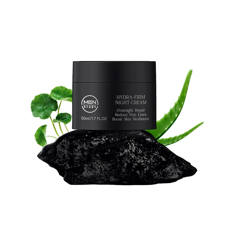 Jar of Men's Hydra-Firm Night Cream surrounded by aloe vera and green leaves on a black stone surface.
