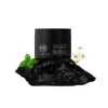 Men's eye cream on dark stone with mint leaves and daisies, suggesting natural ingredients and benefits for eye care.