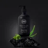 Black bottle of Men Story Hydrating 3-in-1 shampoo, body wash, and face wash on a rock with aloe vera and leaves.