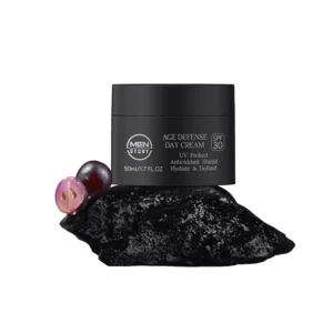 Men's age defense day cream jar on black stone with grape ingredients, labeled with SPF 30 and antioxidant properties.