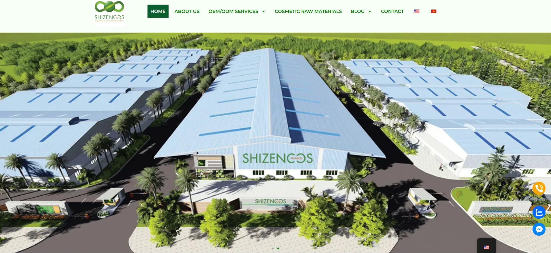 Aerial view of Shizencos industrial complex featuring large buildings surrounded by landscaped greenery and palm trees.