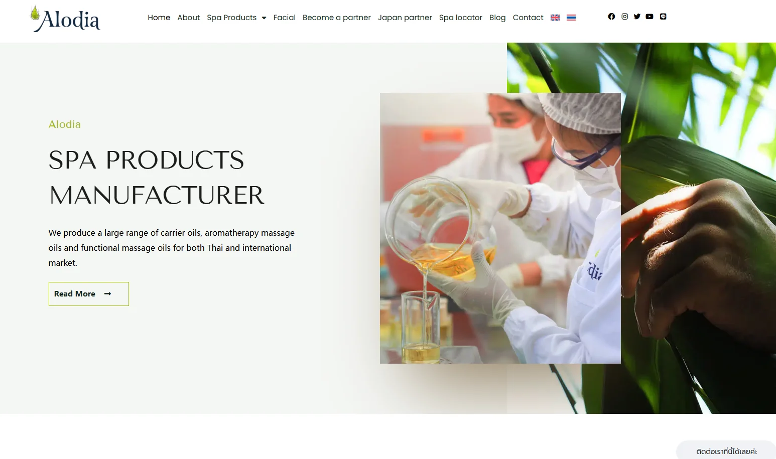 Person in lab coat and gloves pouring oil into a beaker, representing spa products manufacturing process.