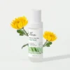 Xiran barrier-boosting face wash bottle surrounded by two vibrant yellow flowers against a light background.