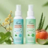 Two XIRAN whole body deodorant spray bottles surrounded by mint leaves, aloe, and other natural elements on a light green background.