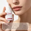 Close-up of a person holding Xiran Post-Procedure Restore Serum with skincare benefits listed on the image.