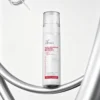 Xiran post-procedure soothing repair mist bottle with a clear design, highlighted by metallic curves in the background.