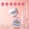 Rice Cake Cleanser jar and packaging displayed on a pink background with water splashes and beakers. Dermatologist-tested, cruelty-free, and free of sulfates, parabens, and phthalates.