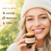 A woman holding a vanilla lip scrub jar with instructions for easy application including scoop, massage, and rinse displayed in text.