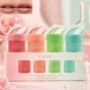 XIRAN lip sleeping mask mini kit featuring four scented jars in berry, grapefruit, apple lime, and mint choco, placed on a soft pink background.