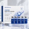 Box and five small blue vials of copper peptide serum displayed on a glass surface, labeled with benefits for skincare.
