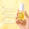 A hand holding a bottle of dual-capsule retinol serum featuring black truffle exosomes and NAD+ on a yellow background.