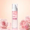 Clear bottle of hydrating oil mist labeled PDRN Exosome Essential Oil Mist by Xiran, surrounded by soft pink roses on a pastel background.