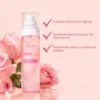 Pink dual-layer PDRN exosome essential oil mist bottle with a jelly-oil design, surrounded by roses on a pastel pink background.