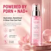 Xiran Hydrating Glow Revival Mist bottle on a reflective surface with pink design elements and product details.