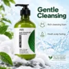 Bottle of anti-dandruff tea tree oil shampoo with a pump dispenser amidst foam and green leaves, promoting gentle cleansing and scalp care.