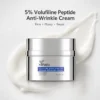 A jar of 5% Volufiline Peptide Anti-Wrinkle Cream with smooth cream texture in the background, promoting firming, plumping, and repair benefits.