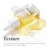 A clear glass dropper bottle partially filled with a dual-phase serum featuring a transparent upper layer and a golden lower layer, with liquid drops and spills around it.