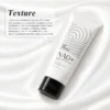 NAD+ Energy Peptide Overnight Mask by XiRan in white and black packaging, placed on a glossy, silky fabric background with product details about its pearlescent texture and gentle application.