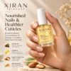 A hand holding a bottle of XIRAN Skincare Nail & Cuticle Oil, emphasizing healthier nails and cuticles with jojoba oil, vitamin E, sweet almond oil, and rice bran oil.