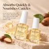 Two bottles of Xiran Skincare Nail and Cuticle Oil placed on a stone surface with almond and oil droplets for decor, promoting hydration and nourishment for nails and cuticles.
